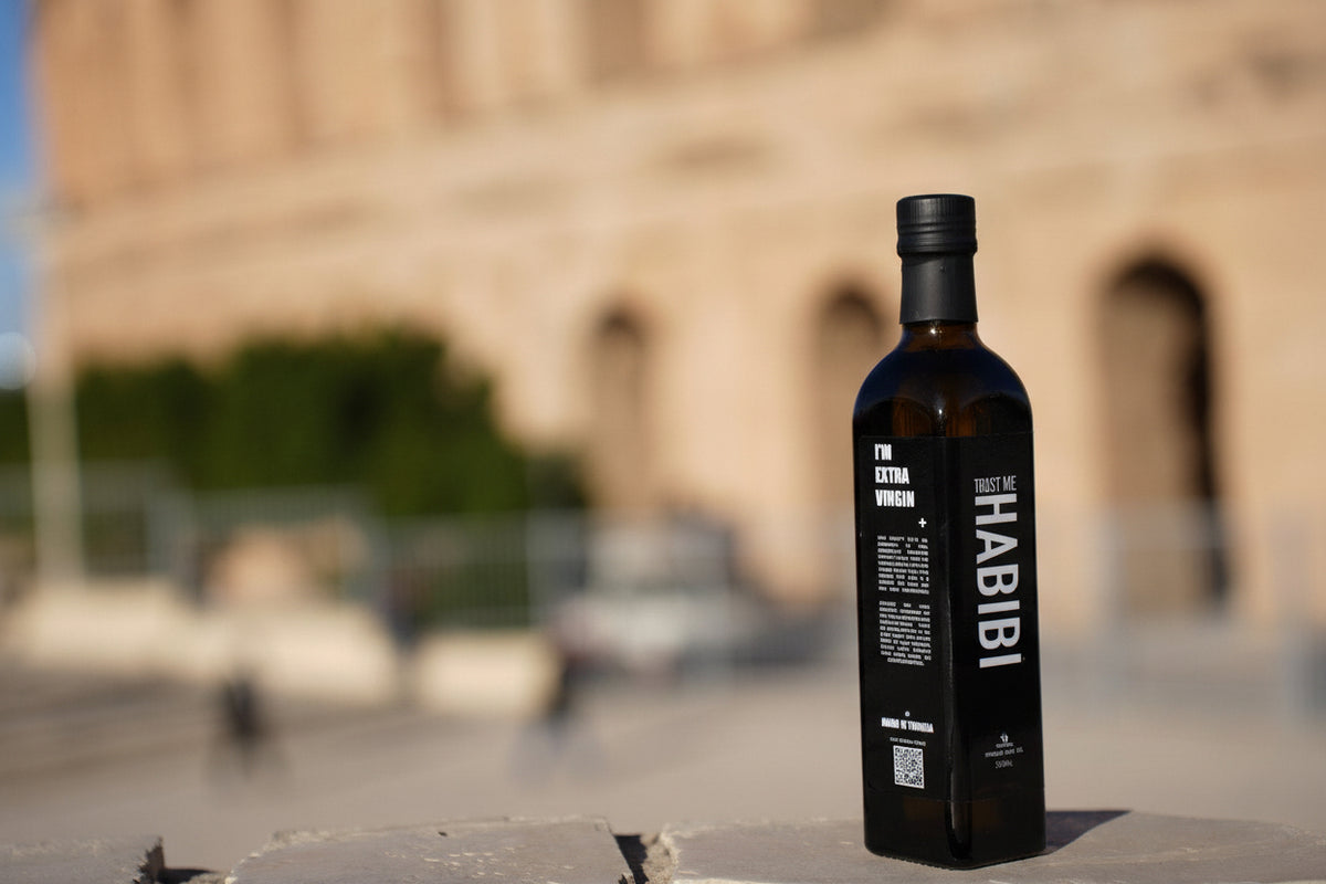 Trust MeHabibi olive oil bottle with Colosseum from El Jem in the background